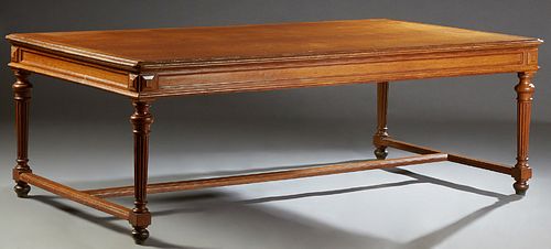 French Louis XVI Style Carved Oak Dining Table, late 19th c., the stepped rounded edge top over a wide skirt, on turned tapered reed...