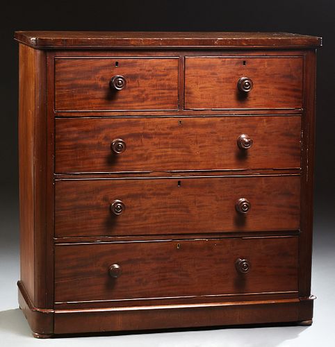 English Victorian Carved Mahogany Manor House Chest, 19th c., the rounded corner top over two deep frieze drawer and three large dee...