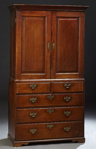 English Carved Oak Linen Press, 19th c., the stepped ogee crown over double cupboard doors over a shelved interior, on a base with t...