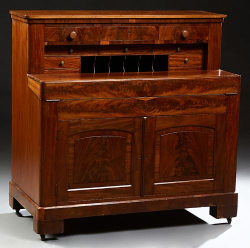 American Carved Mahogany Fall Front Desk, late 19th c., the rectangular top over three frieze drawers above cubbyholes and seven fit...