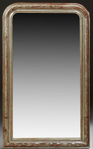 French Louis Philippe Silver Gilt Overmantel Mirror, 19th c., the arched top wide frame with incised floral and leaf decoration, aro...