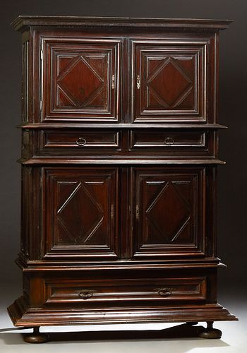 French Carved Oak Louis XIII Style Buffet a Deux Corps, c. 1800, the stepped sloping crown over double cupboard doors with applied g...