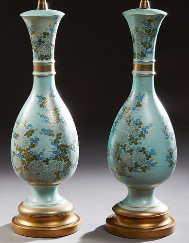 Pair of Oriental Porcelain Baluster Lamps, 20th c., with gilt, silver, and polychromed floral decoration on a pale blue ground, on s...
