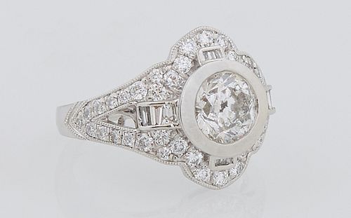 Lady's Platinum Dinner Ring, with a central 1.5 carat round diamond, flanked by pierced diamond mounted lugs