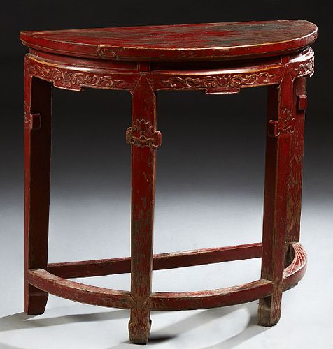 Chinese Polychromed Oak Demilune Table, late 19th c., the top over a wide skirt with floral and tendril carving, on tapered square l...