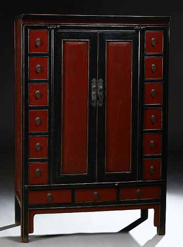 Carved Chinese Black and Red Lacquered Elm Apothecary Cabinet, 19th c., the rounded edge top over double doors flanked by six small...