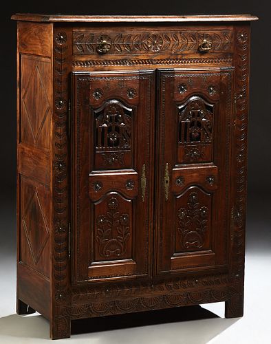 French Provincial Henri II Style Carved Oak Sideboard, 19th c., Brittany, the stepped rounded edge top over a long frieze drawer and...
