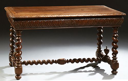 French Louis XIII Style Carved Walnut Writing Table, 19th c., the carved edge top over a sloping indented carved skirt, on rope twis...