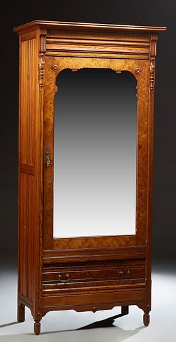 French Carved Pitch Pine Armoire, c. 1880, the stepped ogee crown over a single mirror door above a deep drawer, flanked by reeded p...