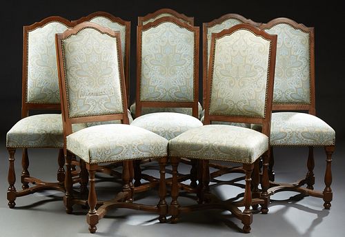 Set of Eight French Louis XVI Style Carved Walnut Upholstered Dining Chairs, early 20th c., the arched rectangular back over a trape...