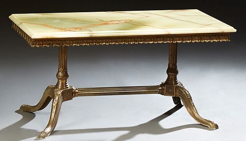 French Louis XV Style Brass and Onyx Coffee Table, 20th c., the ogee edge figured onyx top over a scalloped leaf skirt, on turned ta...