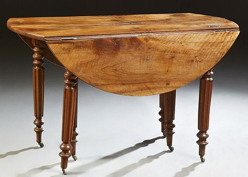 French Louis Philippe Drop Leaf Dining Table, 19th c., the circular top opening to accept leaves, over a wide skirt, on turned taper...
