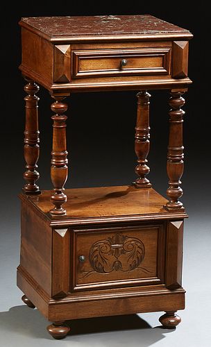 French Louis XVI Style Carved Walnut Marble Top Nightstand, 19th c., the inset rouge marble above a single drawer on tapered and tur...