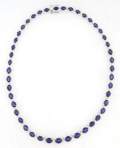 14K White Gold Link Necklace, each of the 45 oval links with a graduated oval blue sapphire, atop a border of round diamonds, total...