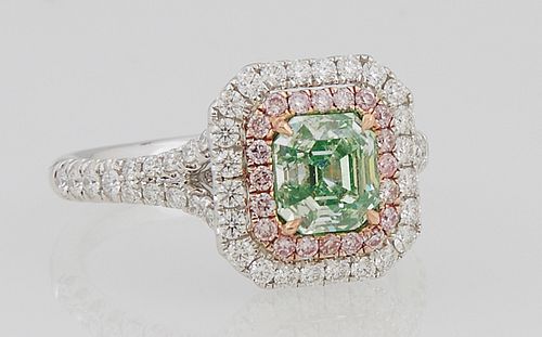 Lady's 18K White Gold Dinner Ring, with an 1.25 carat emerald cut green diamond, within a rose gold border of pink round diamonds an...