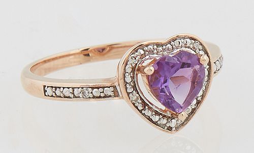 Lady's 14K Yellow Gold Dinner Ring, with a heart shaped amethyst, atop a pierced diamond mounted border, the sides of the band also...
