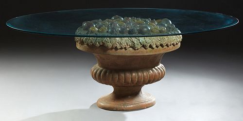 Unusual Continental Oval Beveled Glass Top Dining Table, 20th c., on a polychromed terracotta center urn support topped with relief...