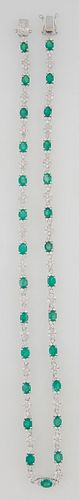 18K White Gold Link Necklace, with 27 oval links mounted with oval emeralds, flanked by diamond mounted triangular lugs, joined by 2...