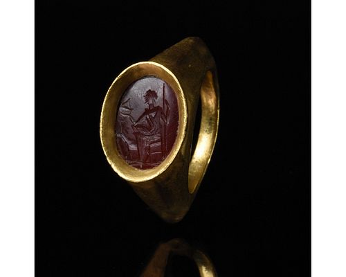 ROMAN GOLD INTAGLIO RING WITH A SEATED GOD