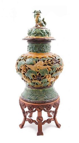 * A Sancai Glazed Pottery Jar and Cover Height of jar 19 inches.