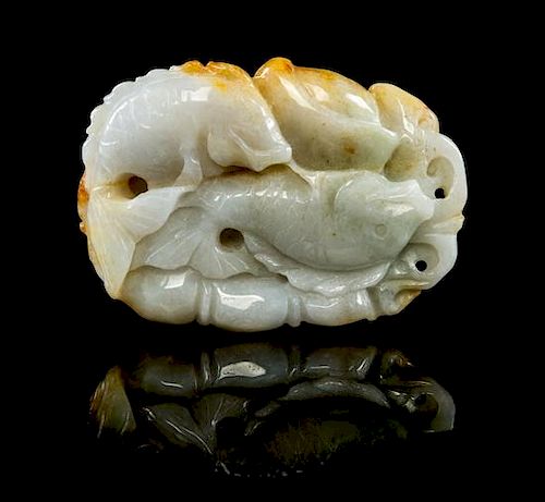* A Carved Jadeite Toggle of Fish Height 2 1/4 inches.