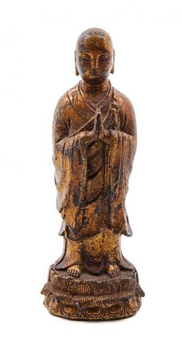 * A Gilt Lacquered Bronze Figure of a Praying Monk Height 7 3/4 inches.