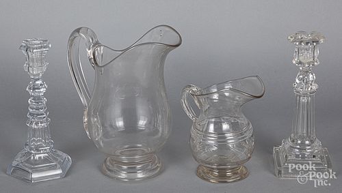Two colorless glass pitchers