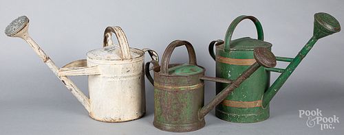 Three painted tin watering cans