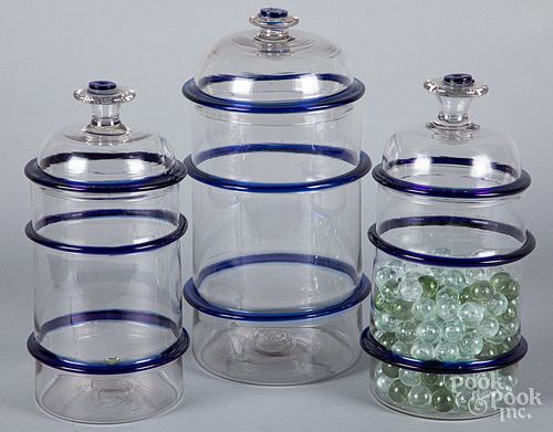 Three clear and cobalt glass apothecary jars