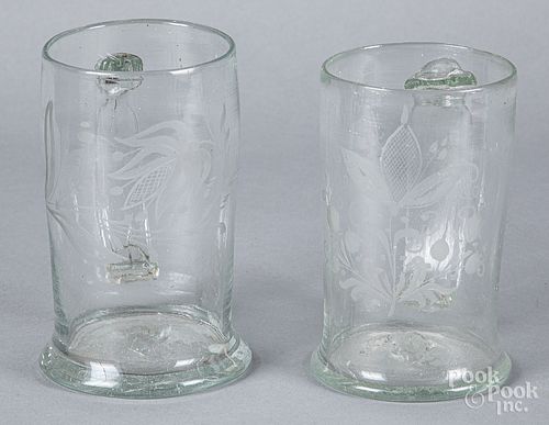 Two Stiegel type etched glass mugs