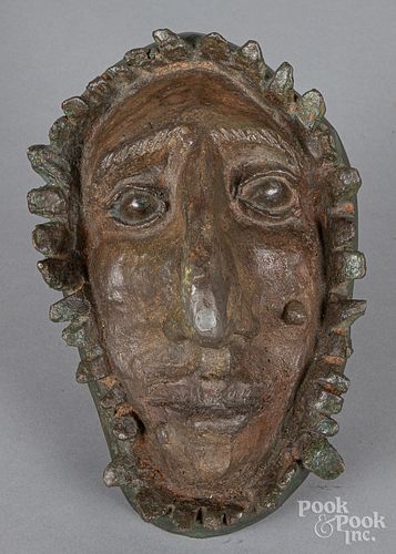Painted cast iron plaque of a man's face