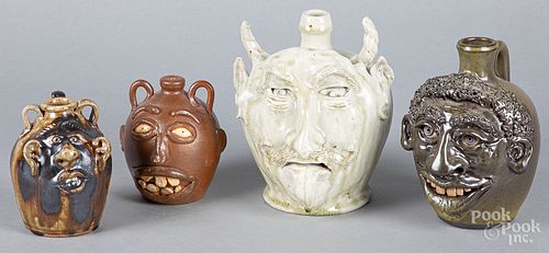 Four southern pottery face jugs