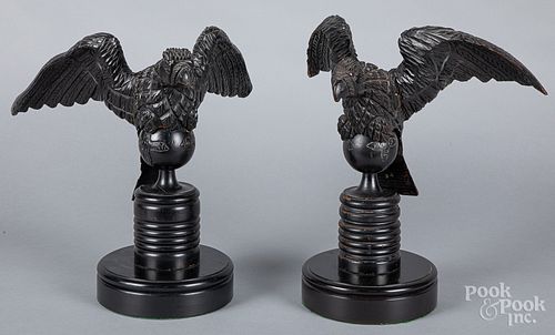 Carved and ebonized eagle, together with another