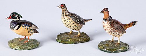 Three miniature carved and painted birds