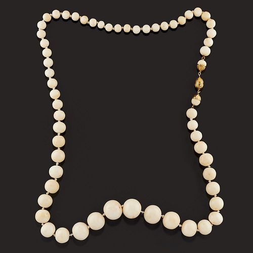 A yellow gold and white coral necklace