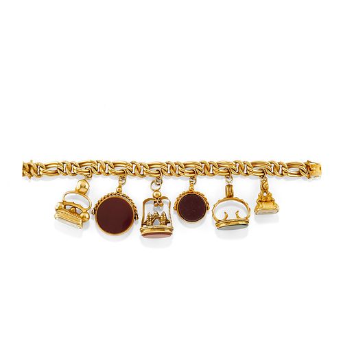 A 14K yellow gold and gemstone charms bracelet