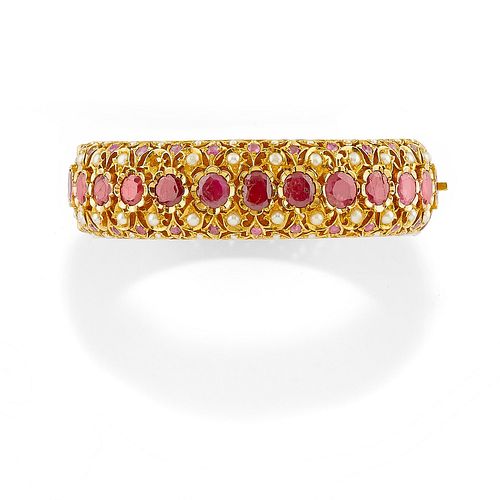 A 18K yellow gold, ruby and pearl bangle