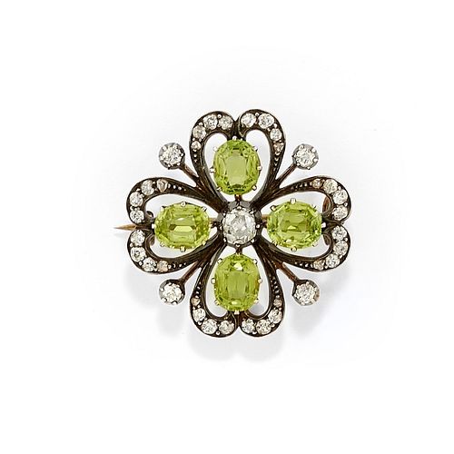 A silver, yellow gold, diamond and green gemstone brooch