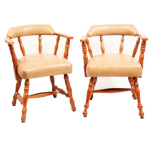 Pair of armchairs. 20th century. Carved in wood. With semi-open backrests and beige leatherette seats.