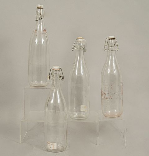 Lot of 4 bottles. 20th century. Made in glass. 12.5 x 3" (32 x 8 cm)