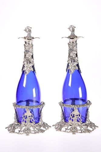A PAIR OF SILVER-PLATE MOUNTED BLUE-GLASS DECANTE