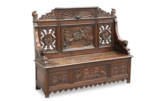 A LATE 19TH CENTURY CARVED OAK SETTLE, the crest 