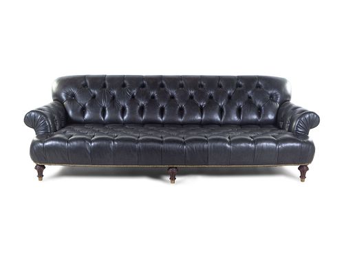An Oversized Black Leather Upholstered Chesterfield Sofa