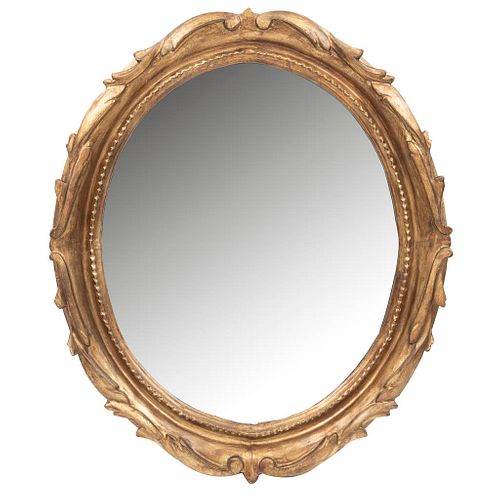Mirror. 20th century. Made in stuccoed, gilded wood. Oval. Decorated with plant elements. 23.6 x 19.6 x 1.9" (60 x 50 x 5 cm)