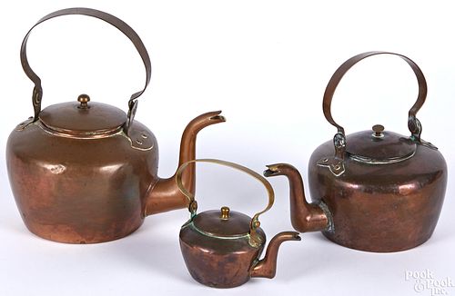 Three small copper kettles