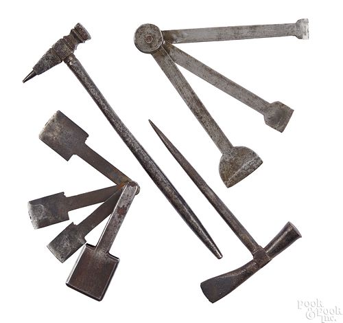 Four wrought iron button hole cutters and hammers