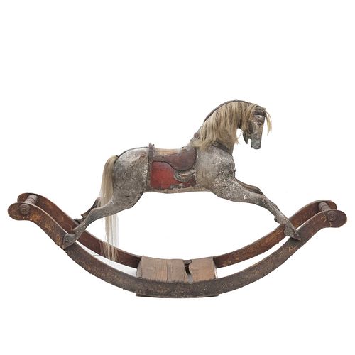 Rocking horse. Late 19th century. Wood carving with polychromy and natural horsehair. Decorated with leather and metal applications.