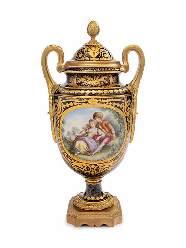 A Sevres Style Gilt Bronze Mounted Painted and Parcel Gilt Porcelain Covered Urn