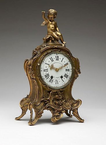 A Louis XV-style gilt bronze mantle clock