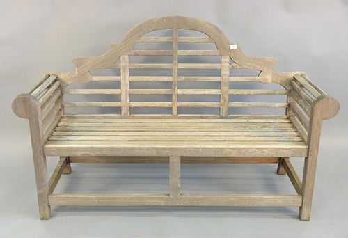 Outdoor teak bench having arch top and rolled arms, ht. 41', lg. 65".